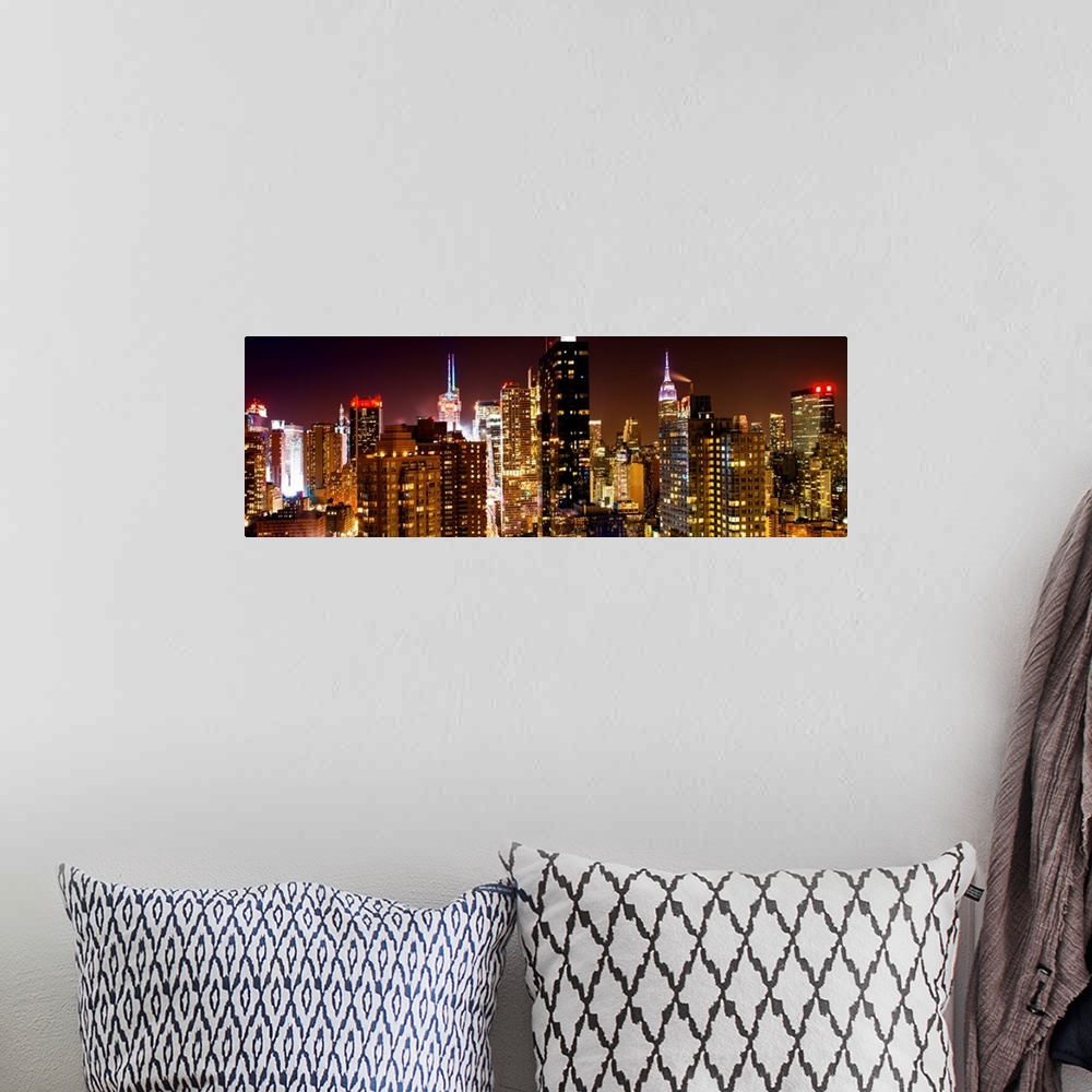 A bohemian room featuring A photograph of New York city at night, with neon light shining bright.