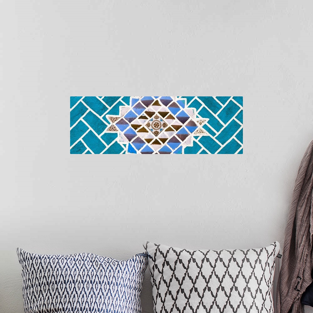 A bohemian room featuring Panoramic photograph of talavera tiles placed together on a wall to create a mosaic design surrou...
