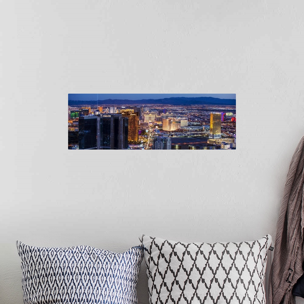 A bohemian room featuring Panoramic photograph of an aerial view of the Las Vegas strip lit up at night.