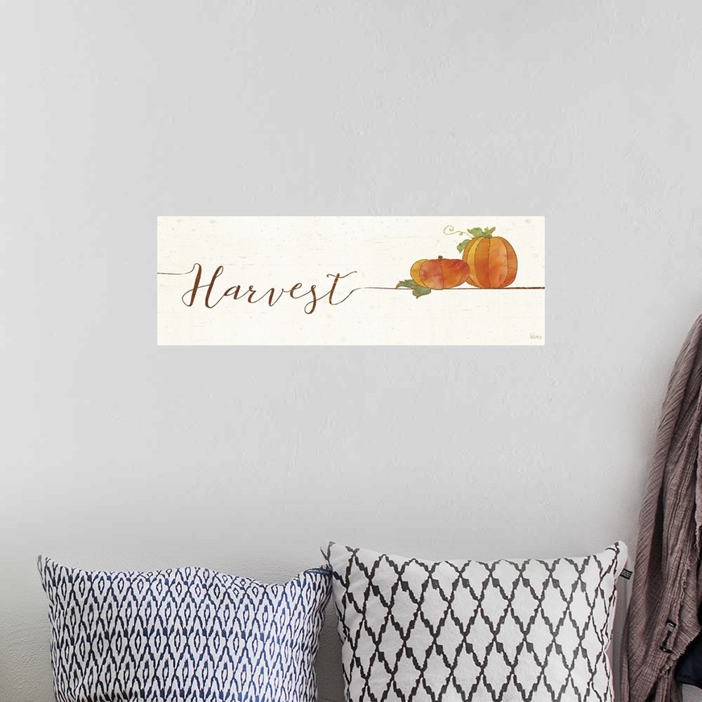 A bohemian room featuring Horizontal artwork of "Harvest" in handwritten text with a pair of pumpkins.