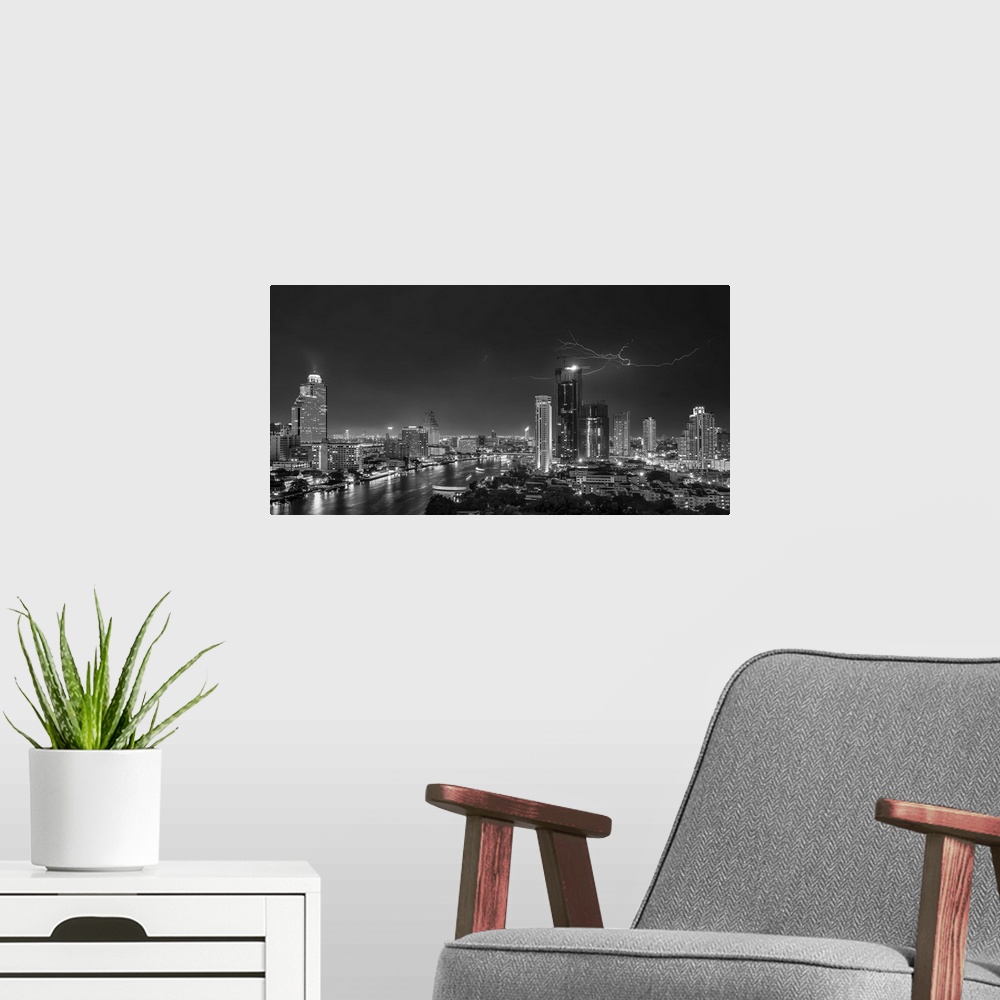 A modern room featuring An aerial photograph of the Bangkok skyline with lightning overhead.