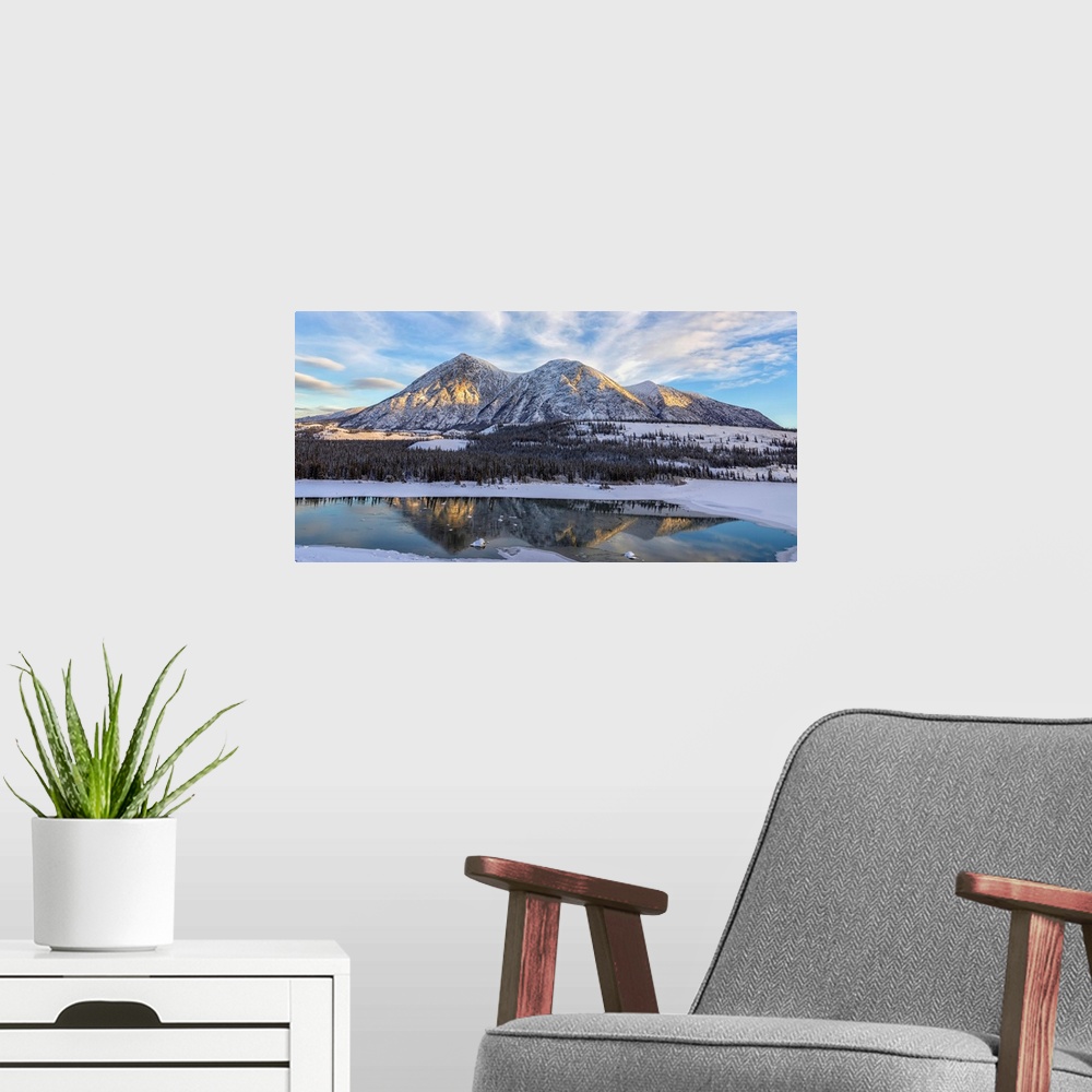 A modern room featuring Late winter afternoon light warms up the mountains along the Takhini River, near Whitehorse. Yuko...