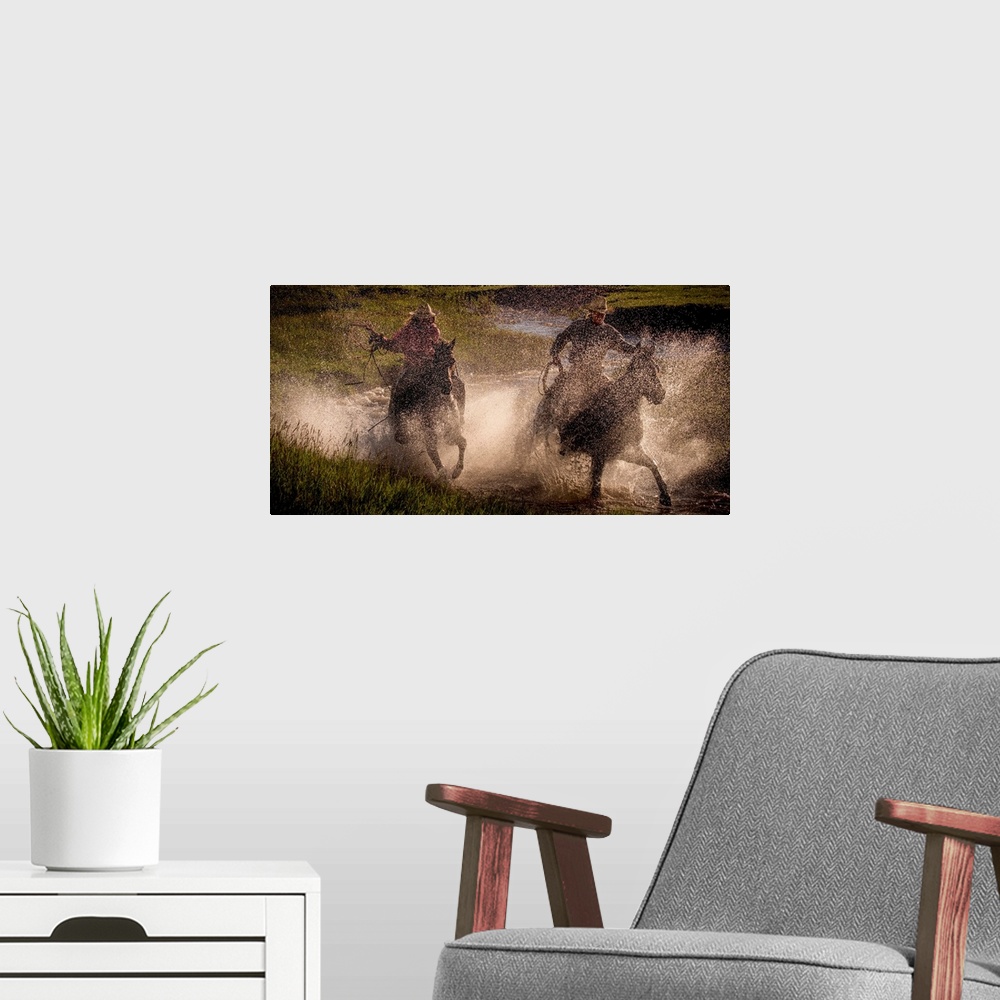 A modern room featuring Photograph of two cowgirls splashing through a steam on horseback with their lassos out.