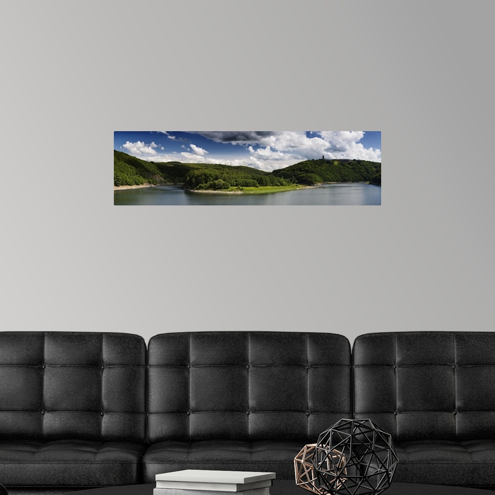 A modern room featuring Panoramic photograph of a lake in the Eifel range in Germany under cloudy skies.