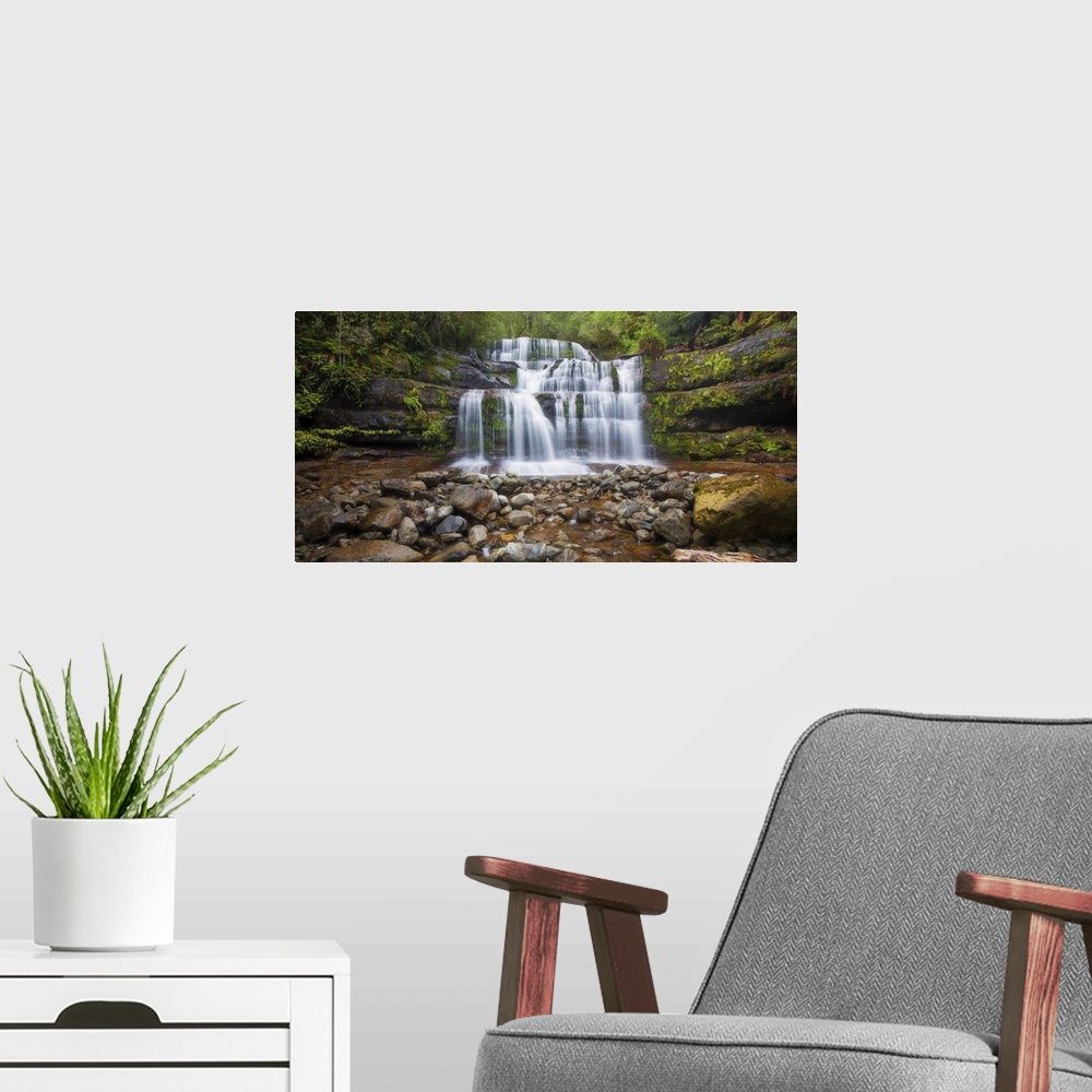 A modern room featuring A photograph of a multi-leveled waterfalls