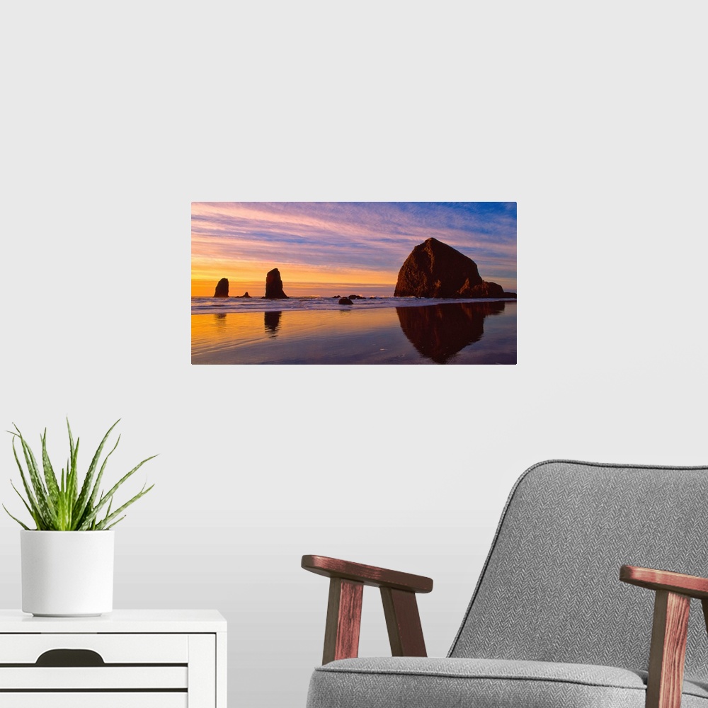 A modern room featuring Sea stacks on the beach silhouetted at sunset, Cannon Beach, Oregon.