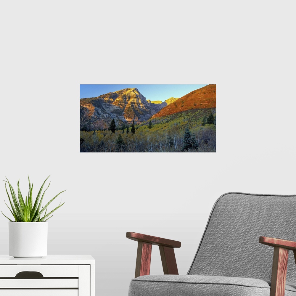 A modern room featuring Light from the setting sun turning the mountains red in Utah.