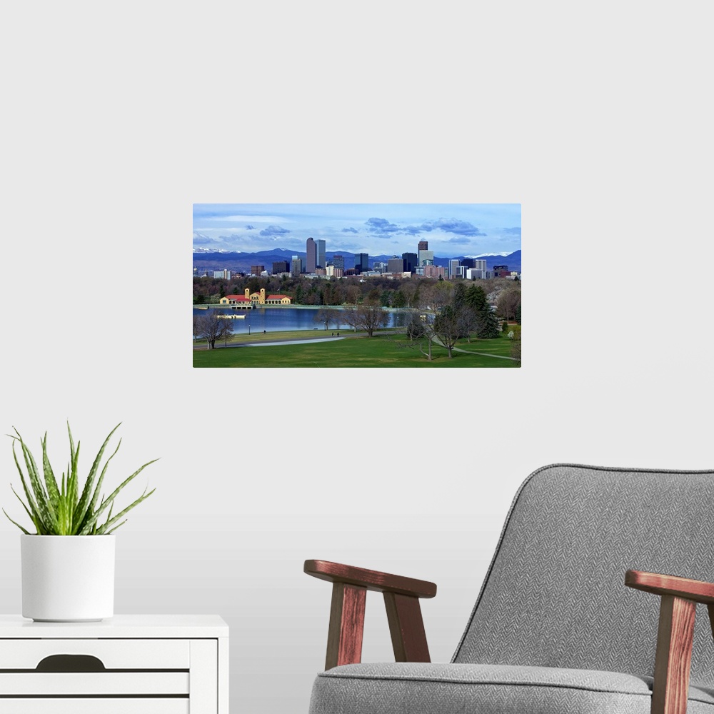 A modern room featuring Denver Skyline from City Park with boat house and lake and Mt. Evans in background.
