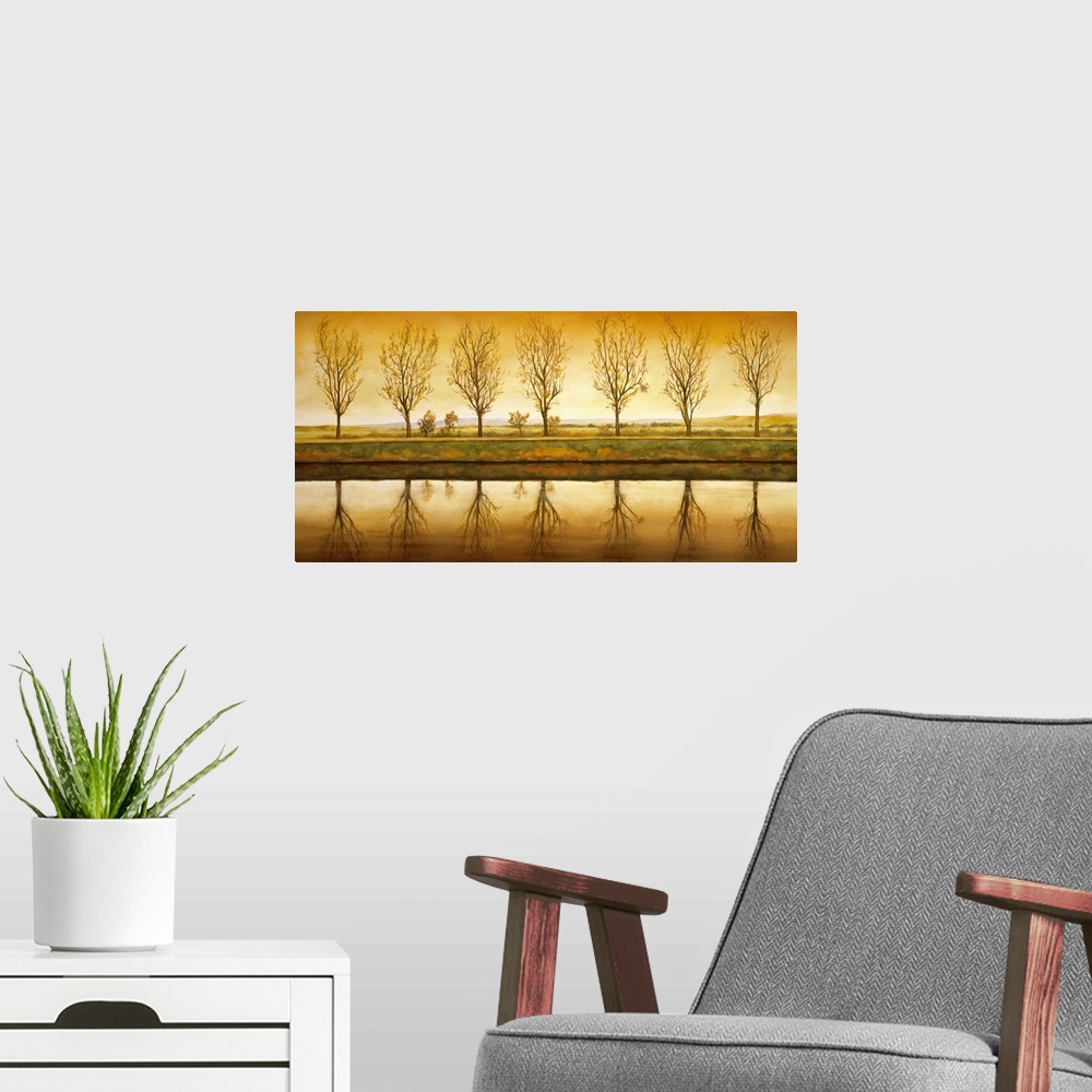 A modern room featuring Contemporary art on a landscape canvas of a line of seven trees with nearly bare branches, reflec...