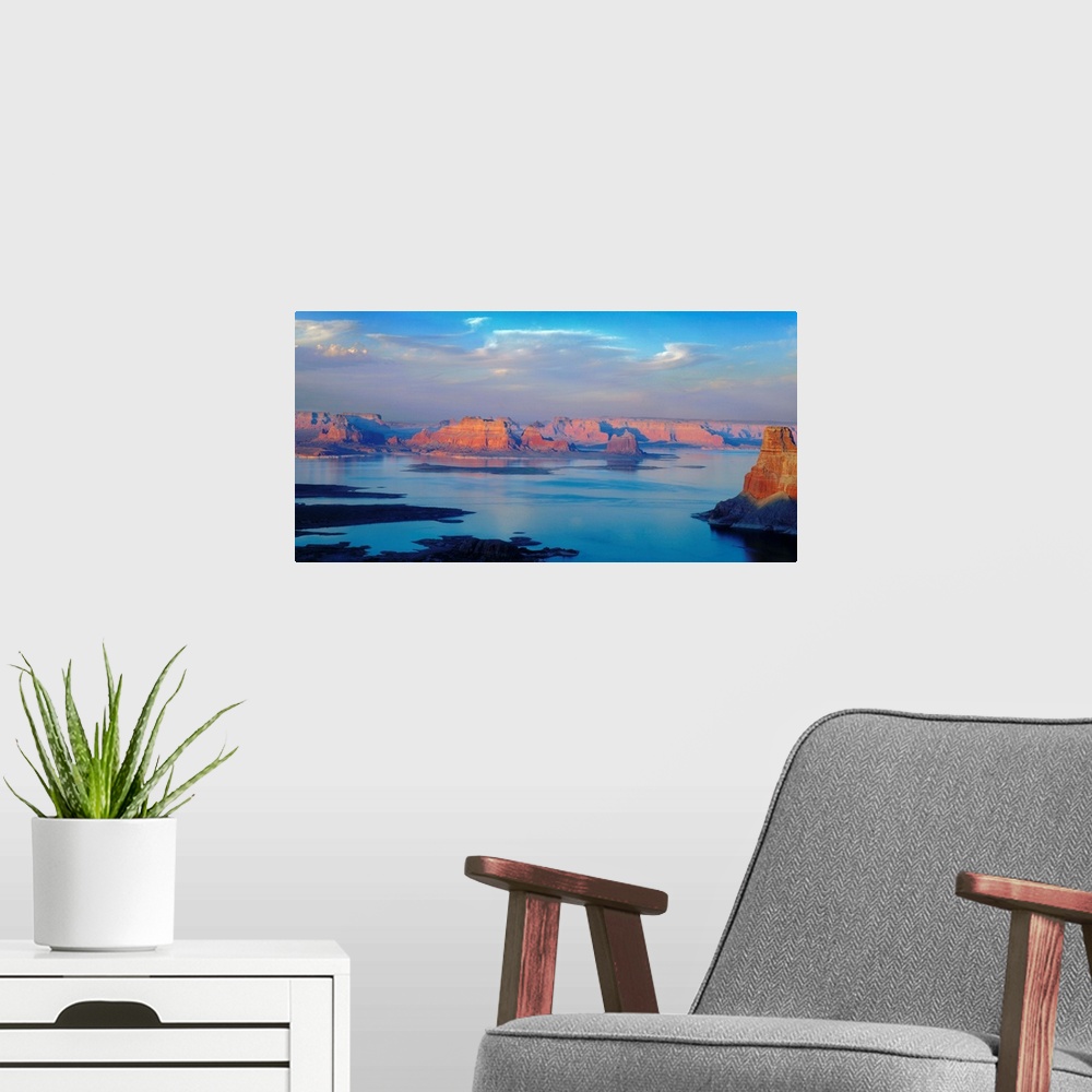 A modern room featuring A photograph of lake powell under sky with approaching clouds.