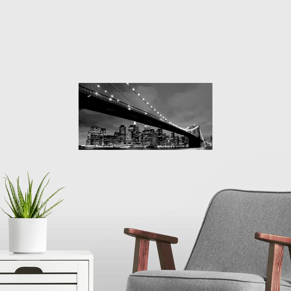A modern room featuring Black and white panoramic of the Brooklyn Bridge with New York City in the background.