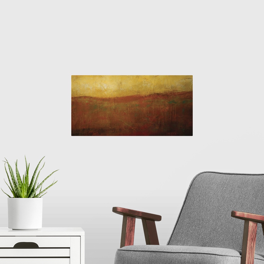 A modern room featuring Abstract artwork of a golden hued sunrise illuminating a smoky orange hilltop.