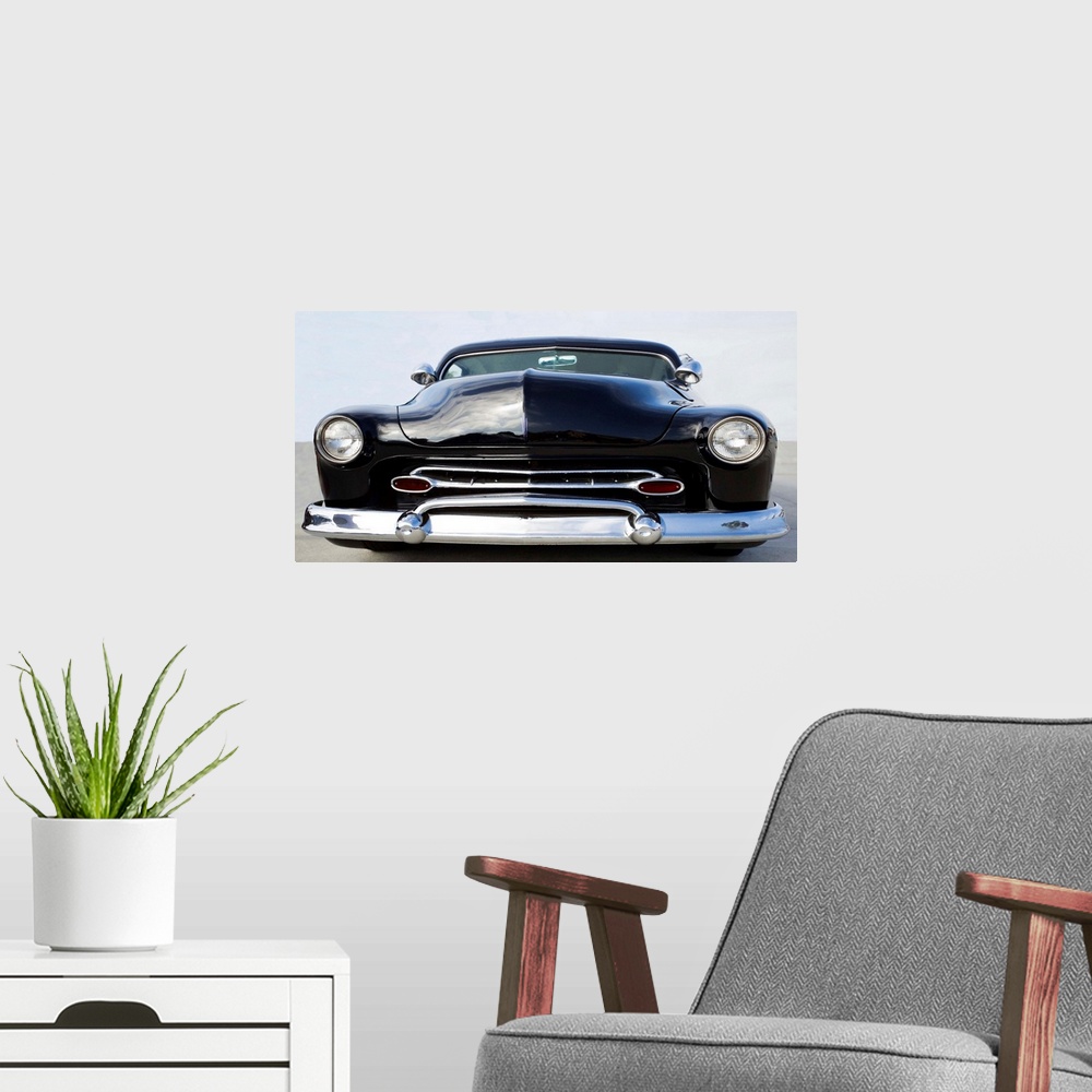 A modern room featuring Photograph in black and white of the front end of a classic hot rod.