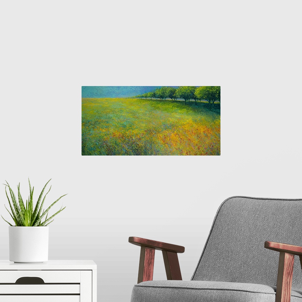 A modern room featuring Brightly colored contemporary artwork of a landscape of trees bordering a field of flowers.