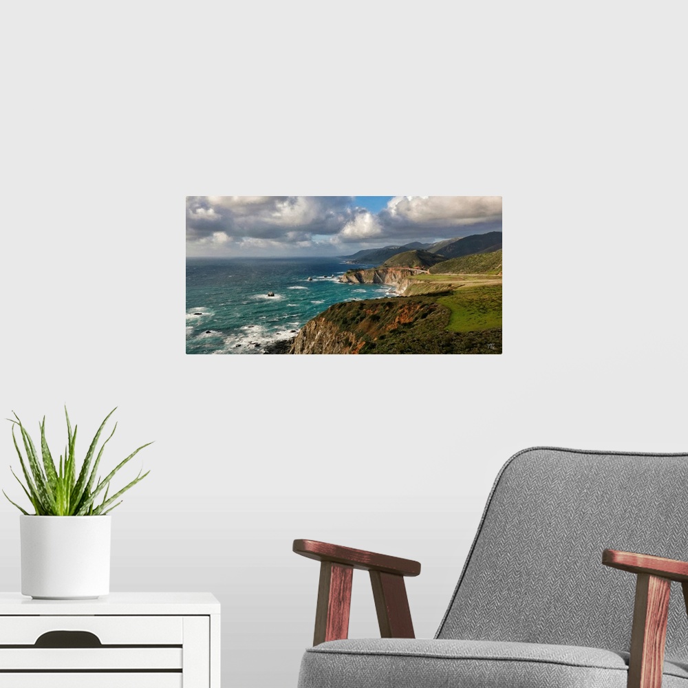 A modern room featuring A view of the Big Sur coastline from Hurricane Point, with the Bixby Creek Bridge glowing in the ...