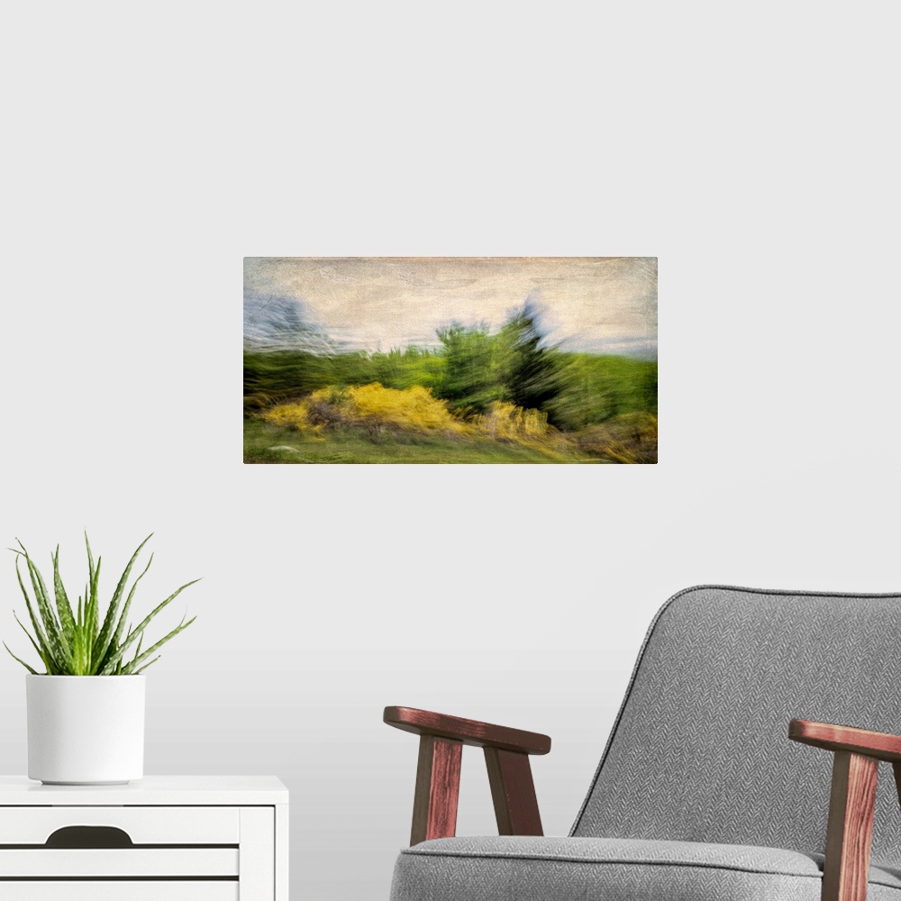 A modern room featuring A turbulent scene of the wind stirring up the trees and clouds.
