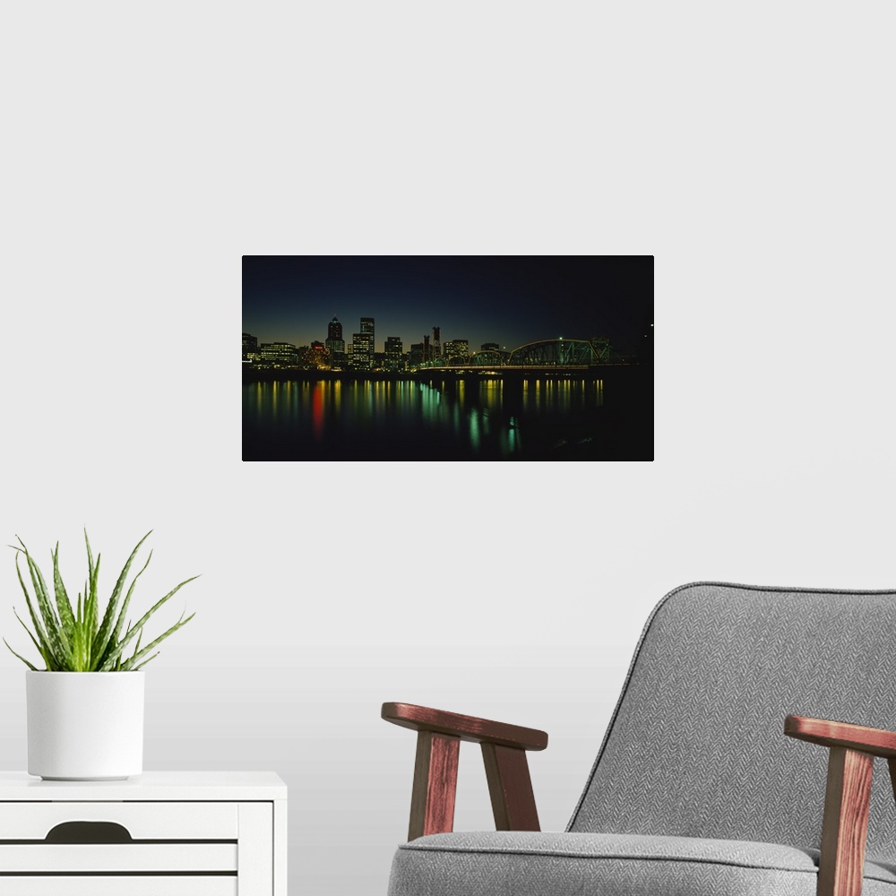 A modern room featuring Panoramic photograph taken of a busy city in the Northwestern United States during nighttime.  Th...