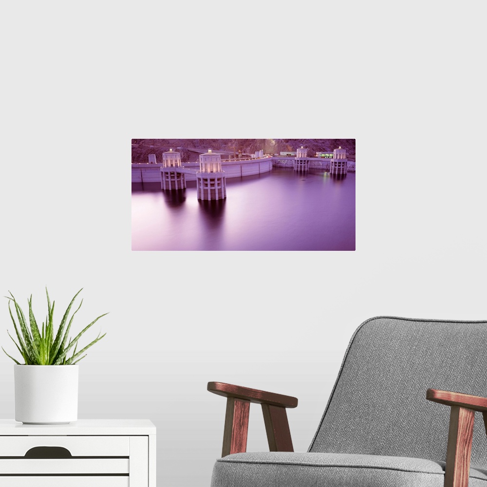 A modern room featuring Horizontal photograph of the still surface of an impounded lake at twilight next to a concrete ar...