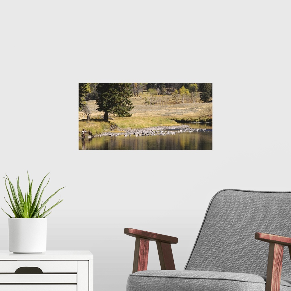 A modern room featuring Fisherman fly fishing in a stream, Yellowstone National Park, Wyoming