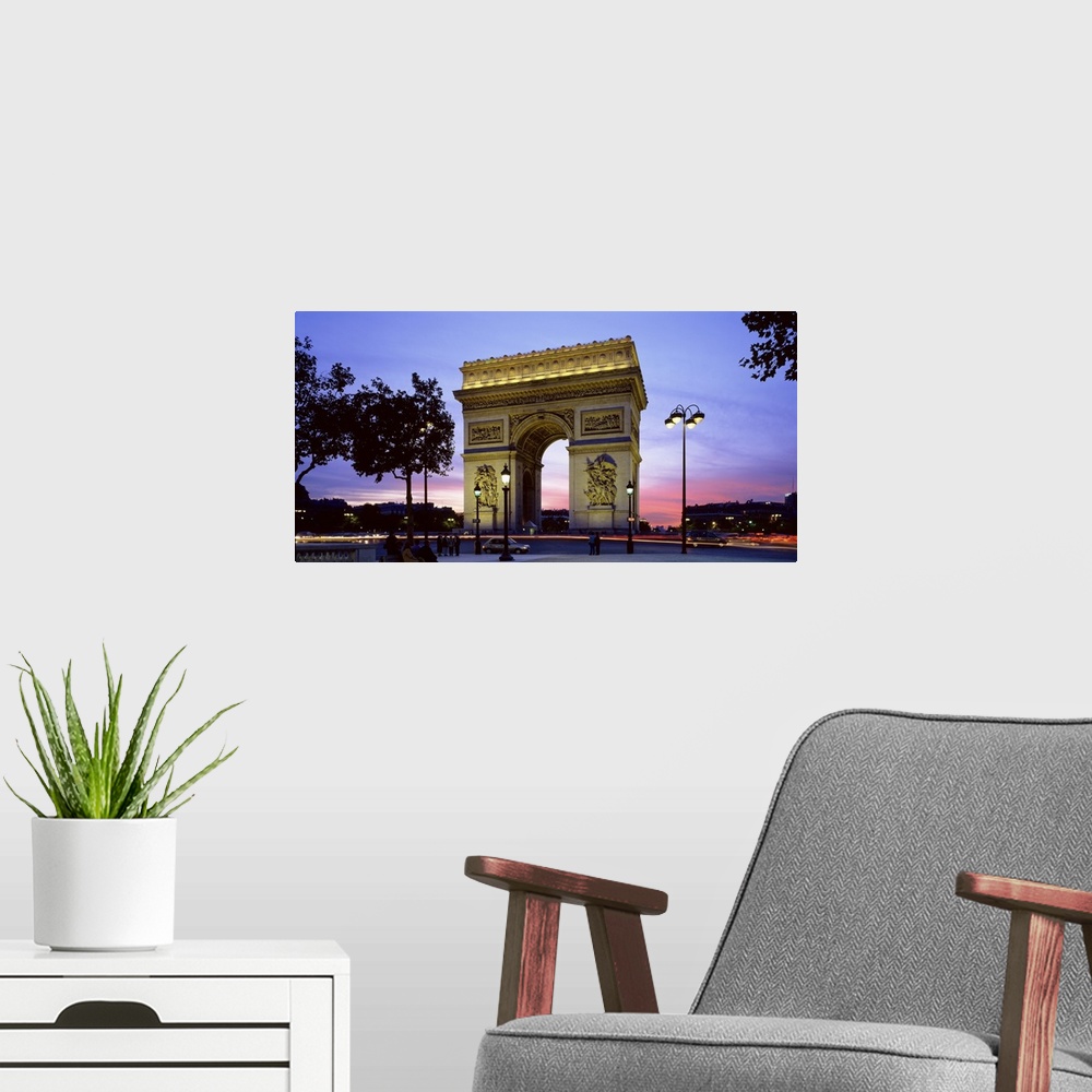 A modern room featuring Panoramic photo on canvas of a monument in Paris at dusk.