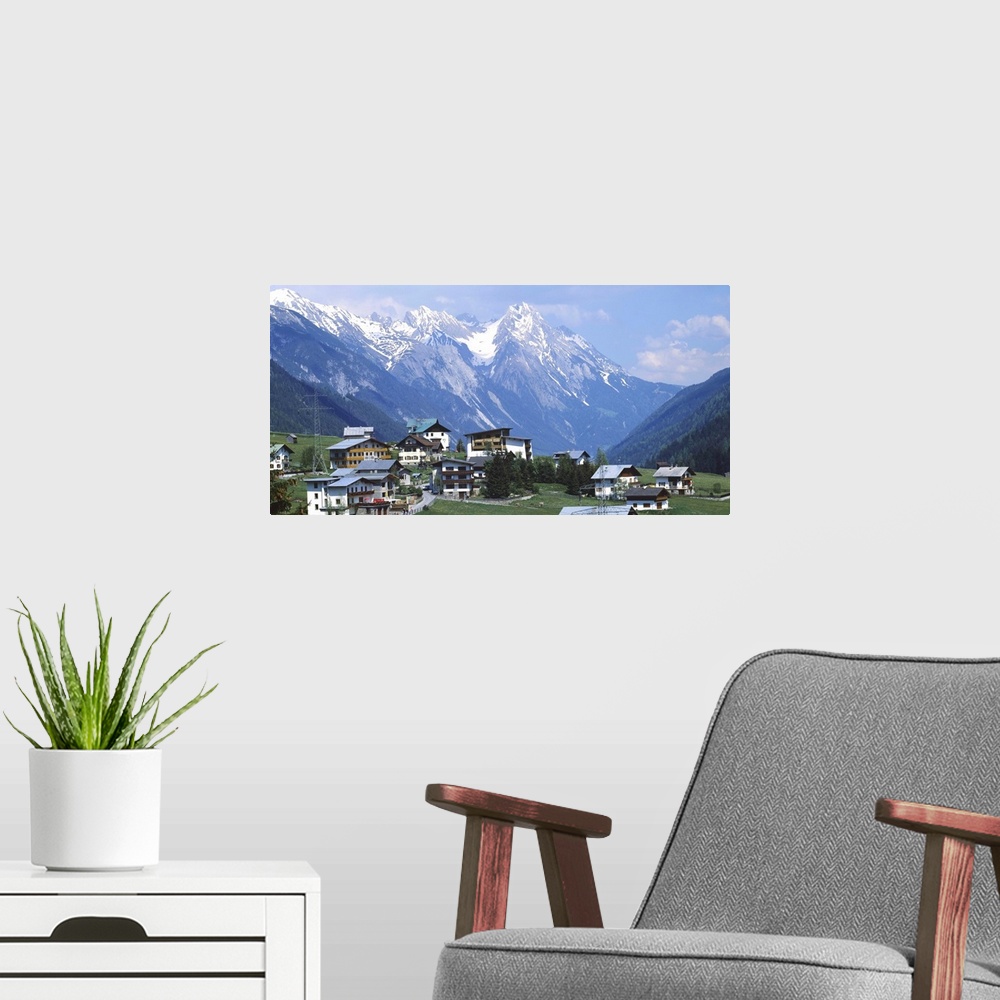 A modern room featuring High angle view of a village on a landscape and a mountain range in the background, St. Anton, Au...