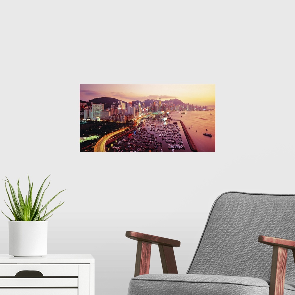 A modern room featuring Large photograph of a harbor in Hong Kong at sunset. Hundreds of boats and many buildings can be ...