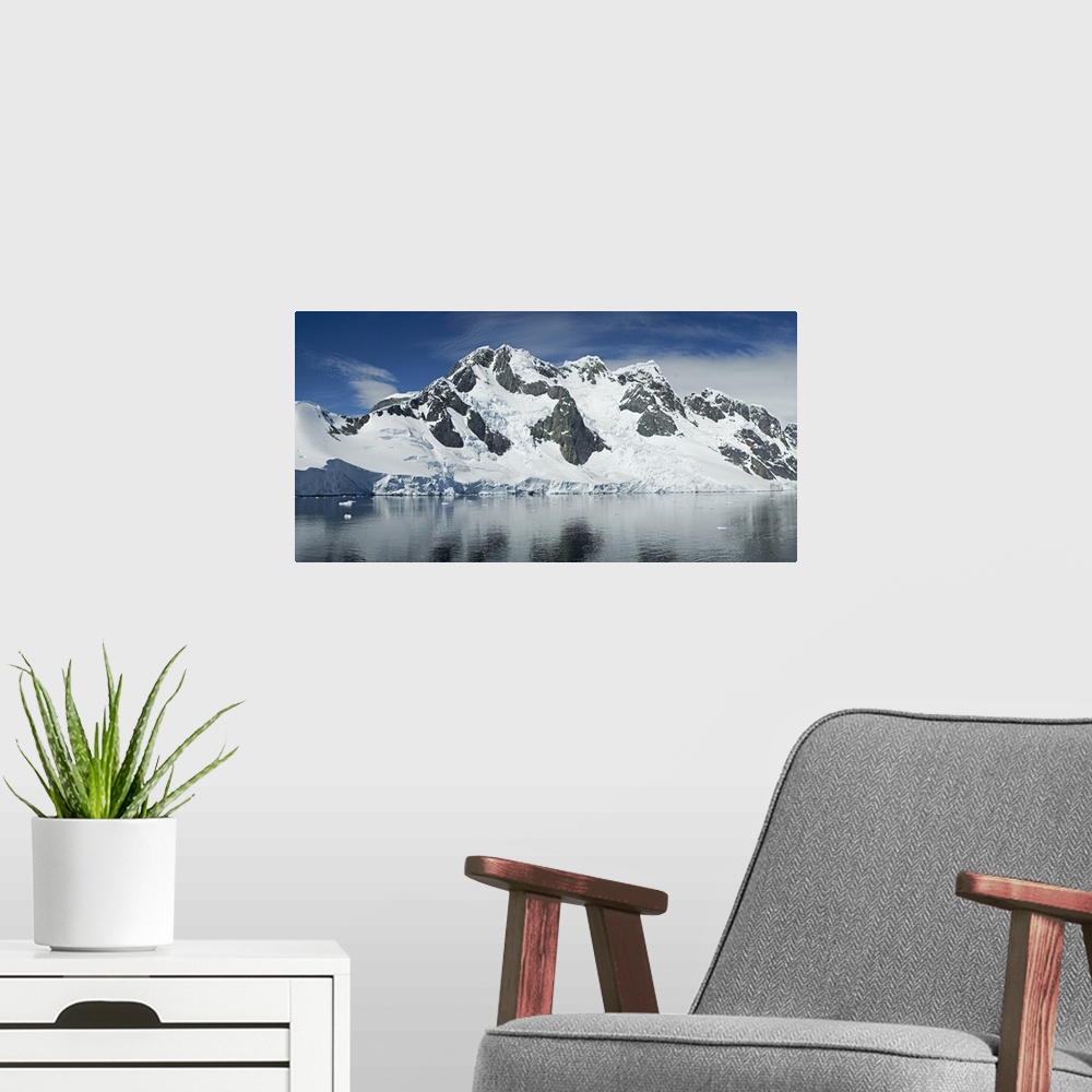 A modern room featuring Reflection of a snow covered mountain in water, Antarctic Peninsula, Antarctica