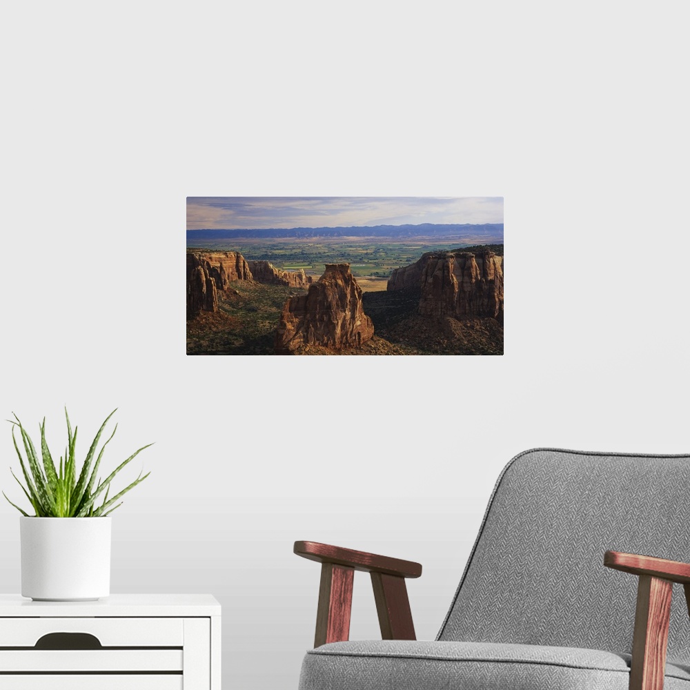 A modern room featuring Big, landscape photograph of large rocks of the Colorado National Monument in Grand Junction, Col...