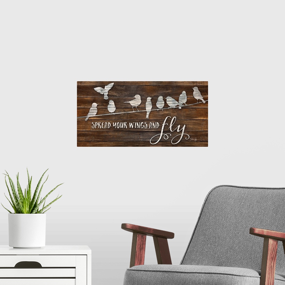 A modern room featuring "Spread Your Wings and Fly" with a design of birds on a line on a brown wood plank background.