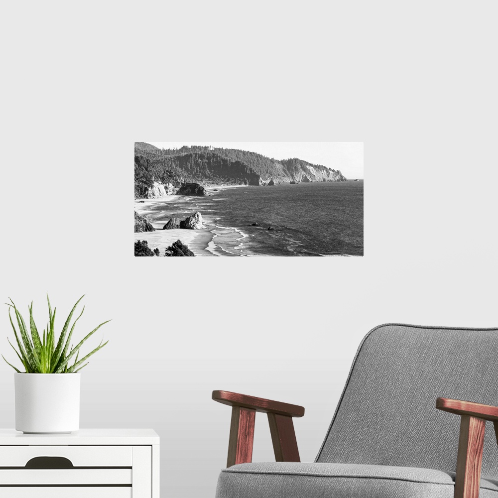 A modern room featuring Black and white landscape photograph of the Cannon Beach shore in Oregon.