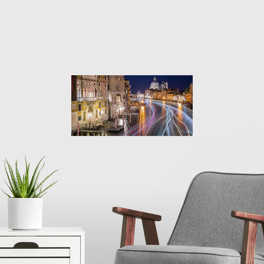 A modern room featuring Long exposure photograph of the Grand Canal in Venice lit up at night with light trails from wate...