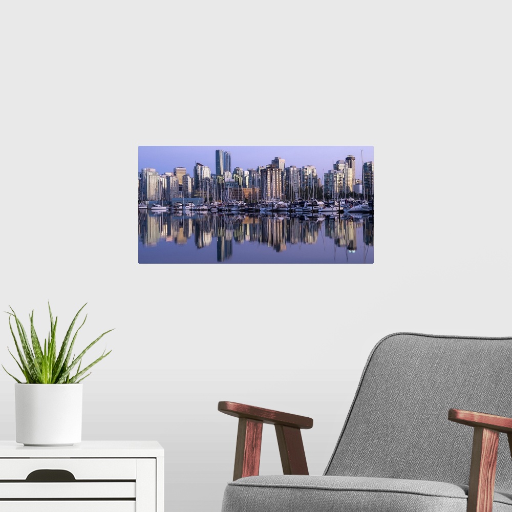 A modern room featuring Photograph of a purple sunset over the Vancouver skyline and harbor reflecting onto the False Cre...
