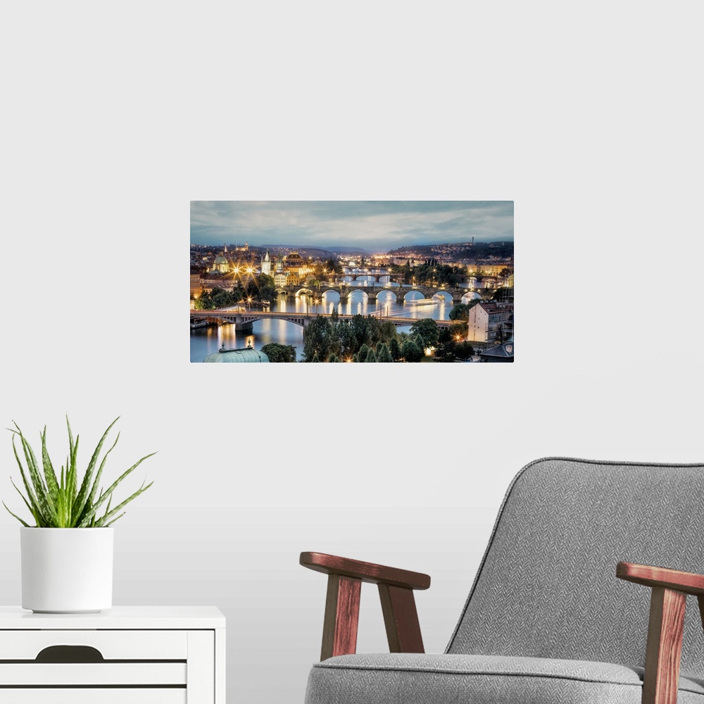 A modern room featuring Panorama of Vltava River and bridges in Prague at sunset.
