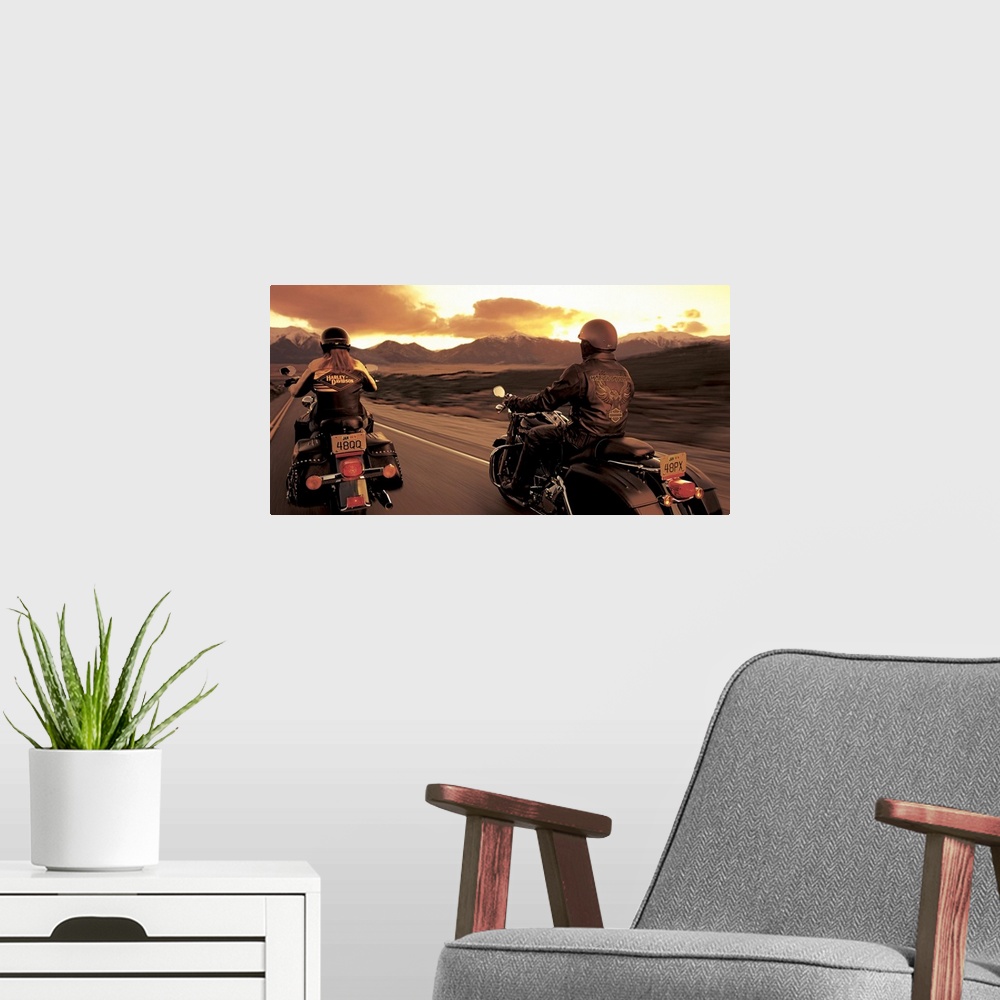 A modern room featuring A couple ride their motorcyles alongside of each other while cruising at sunset