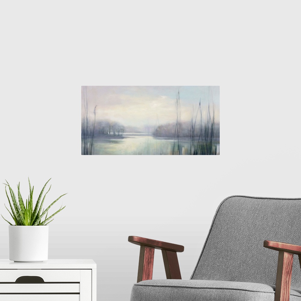 A modern room featuring Large horizontal contemporary landscape of a lake covered in mist in muted tones of blue and gray.