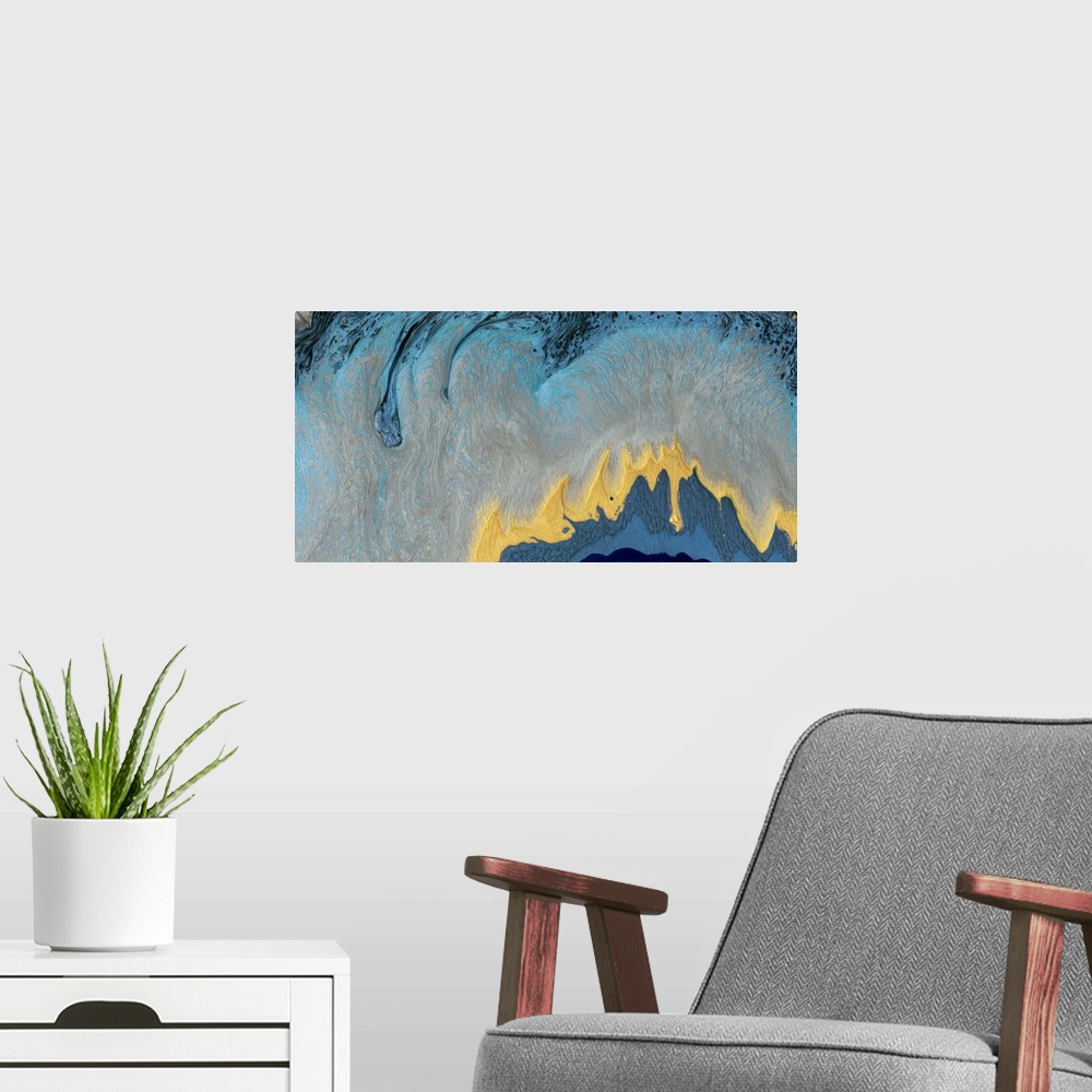 A modern room featuring This contemporary artwork features fluid paint in blue, gray and gold to reflect the elegant moti...