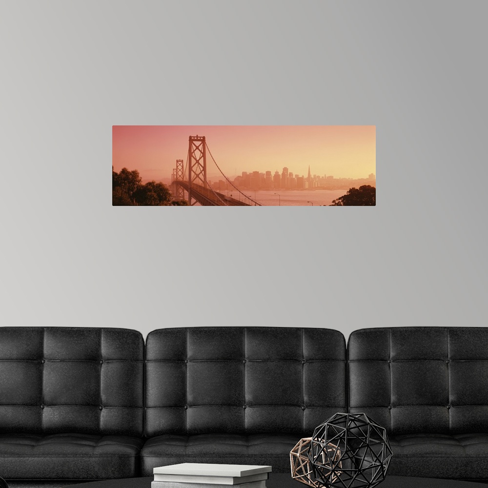 A modern room featuring Panoramic photograph of overpass crossing water with city skyline in the distance.