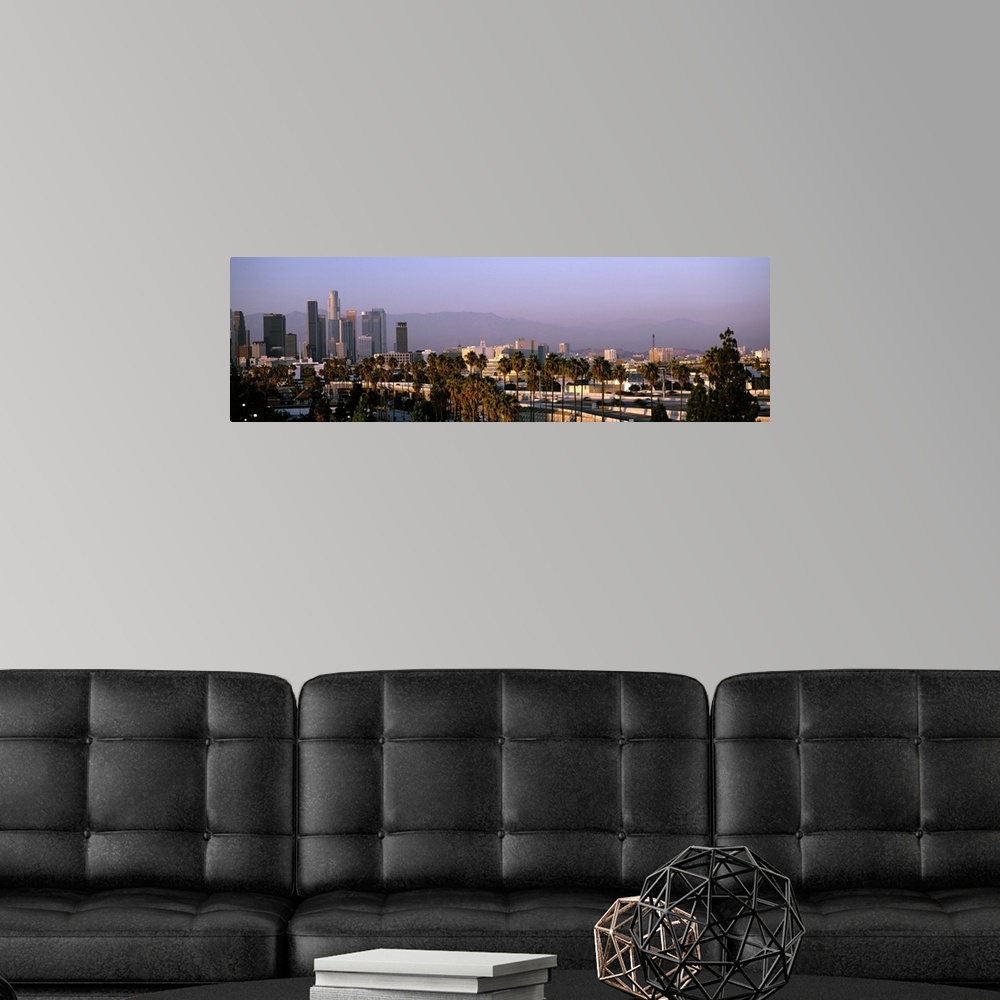 A modern room featuring Panoramic photograph of cityscape under fog with mountain silhouette in the distance.