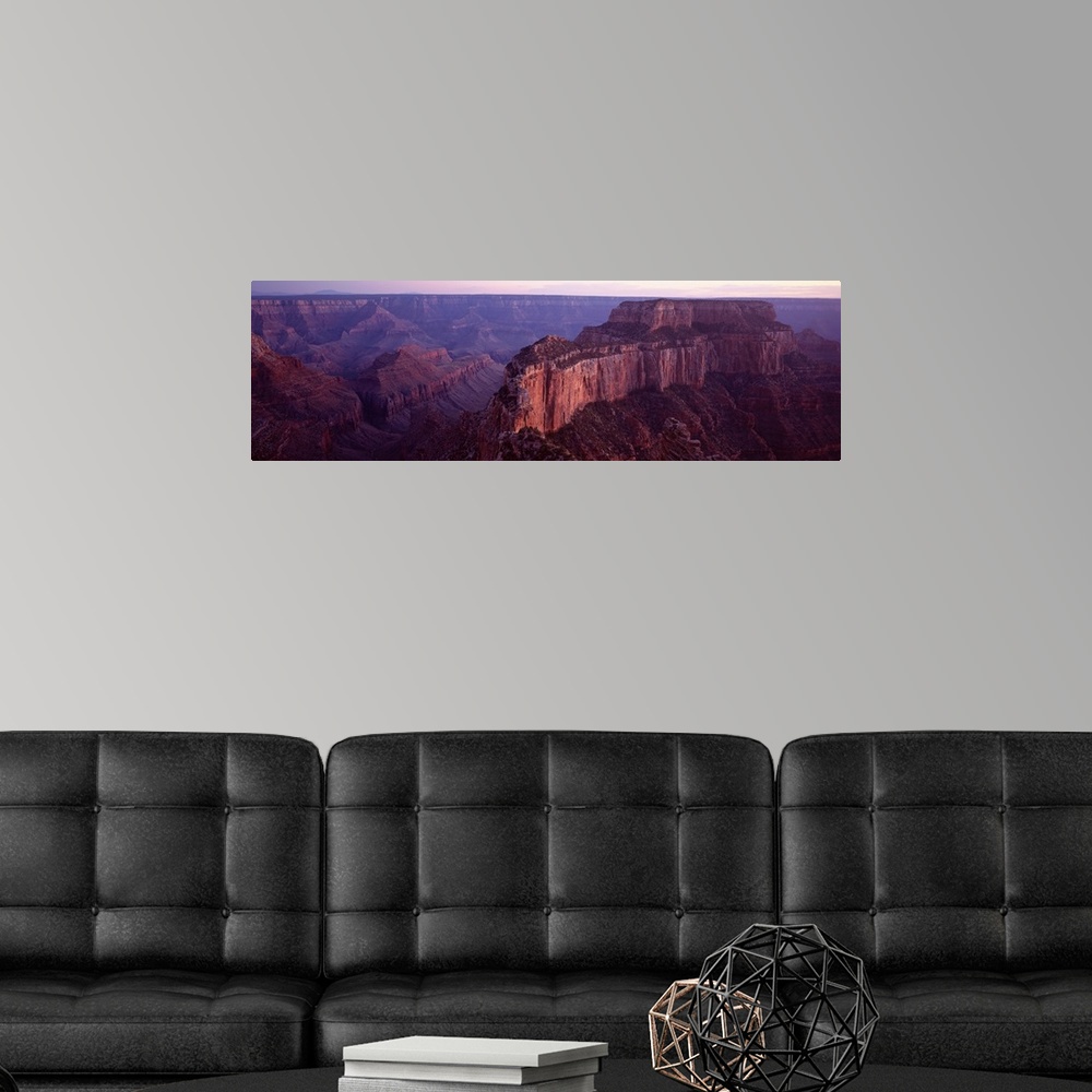A modern room featuring This aerial wide angle shot is taken of the vast Grand Canyon during dusk and only a sliver of th...