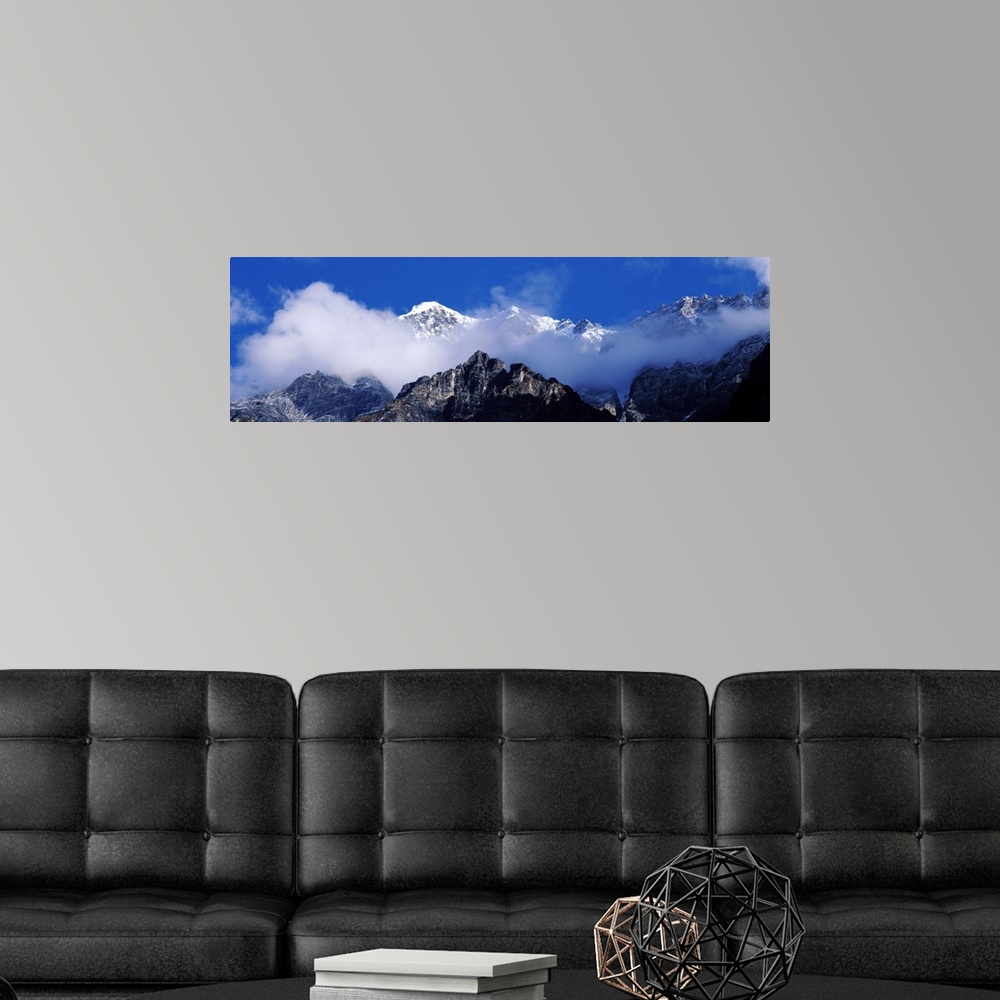 A modern room featuring Nepal, Manaslu Trek, Low angle view of clouds around mountain peaks