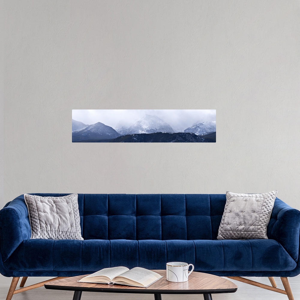 A modern room featuring Storm clouds over snow covered mountains, Rocky Mountain National Park, Colorado,