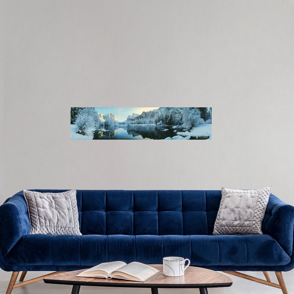A modern room featuring Giant, panoramic photograph of calm waters surrounded by snow covered trees and mountains in Yose...