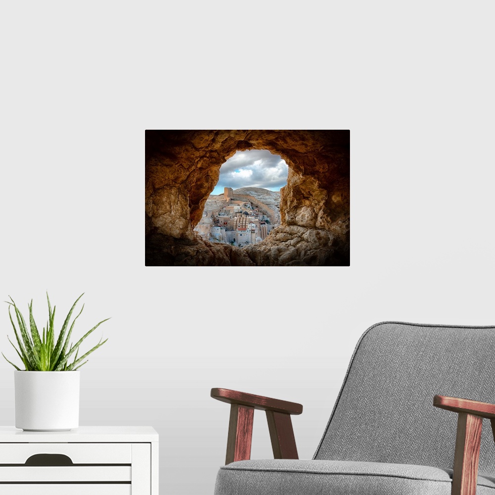 A modern room featuring View of Mar Saba Monastery in Israel from a hole in a rocky wall.