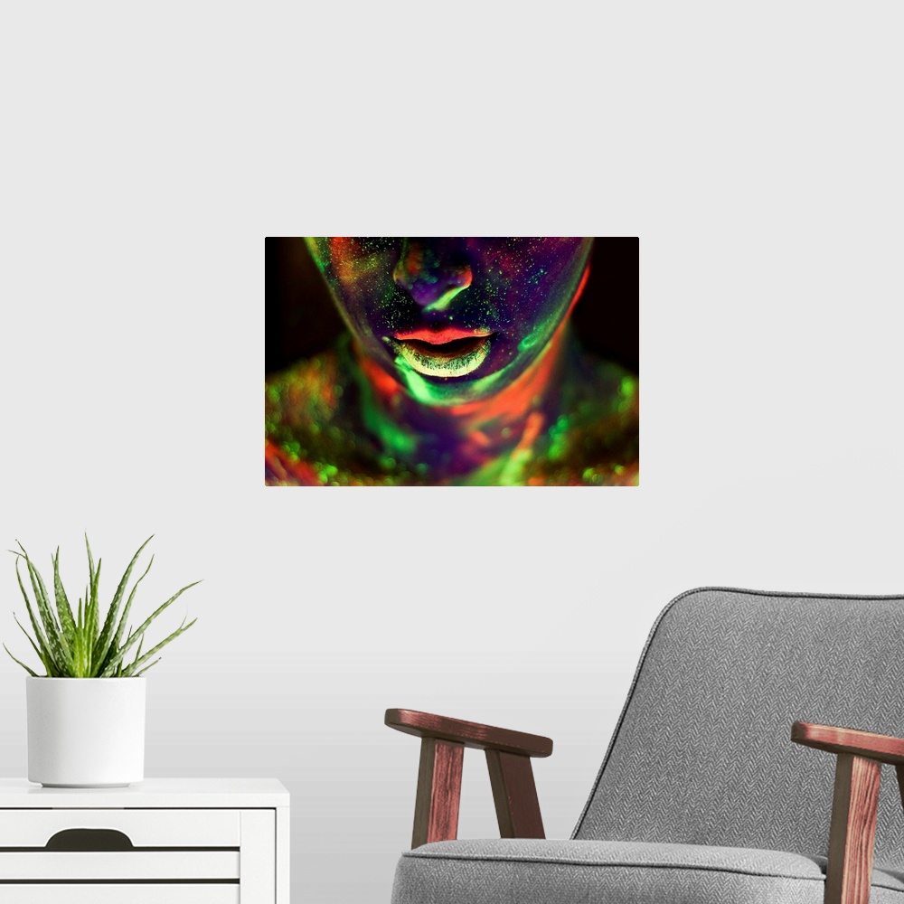 A modern room featuring A woman's face and neck covered in glow-in-the-dark paint in neon colors.