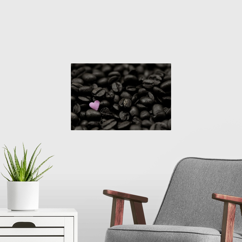 A modern room featuring Close-up photograph of dark coffee beans and a single pink heart.