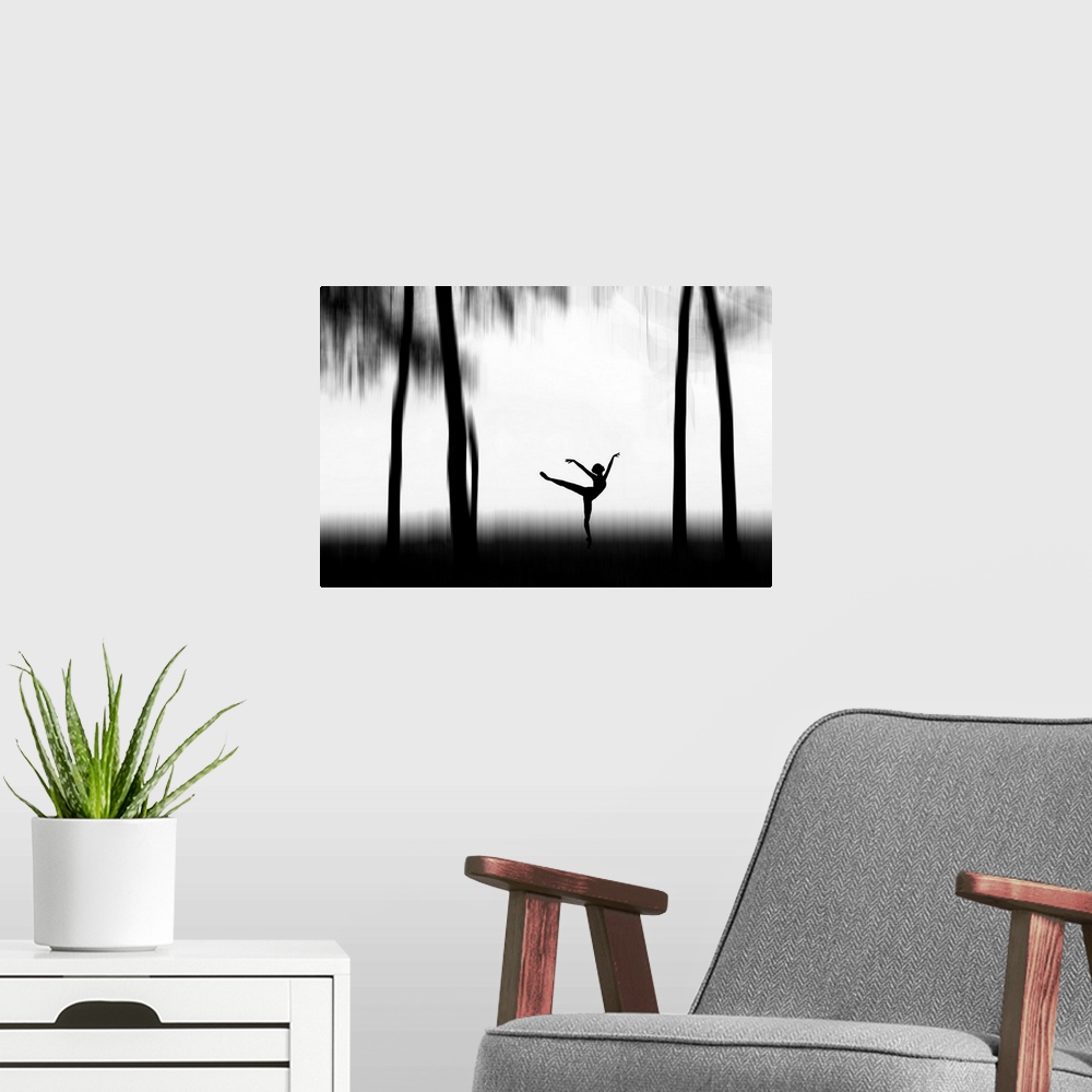 A modern room featuring Silhouette of a dancer posing between tall trees.