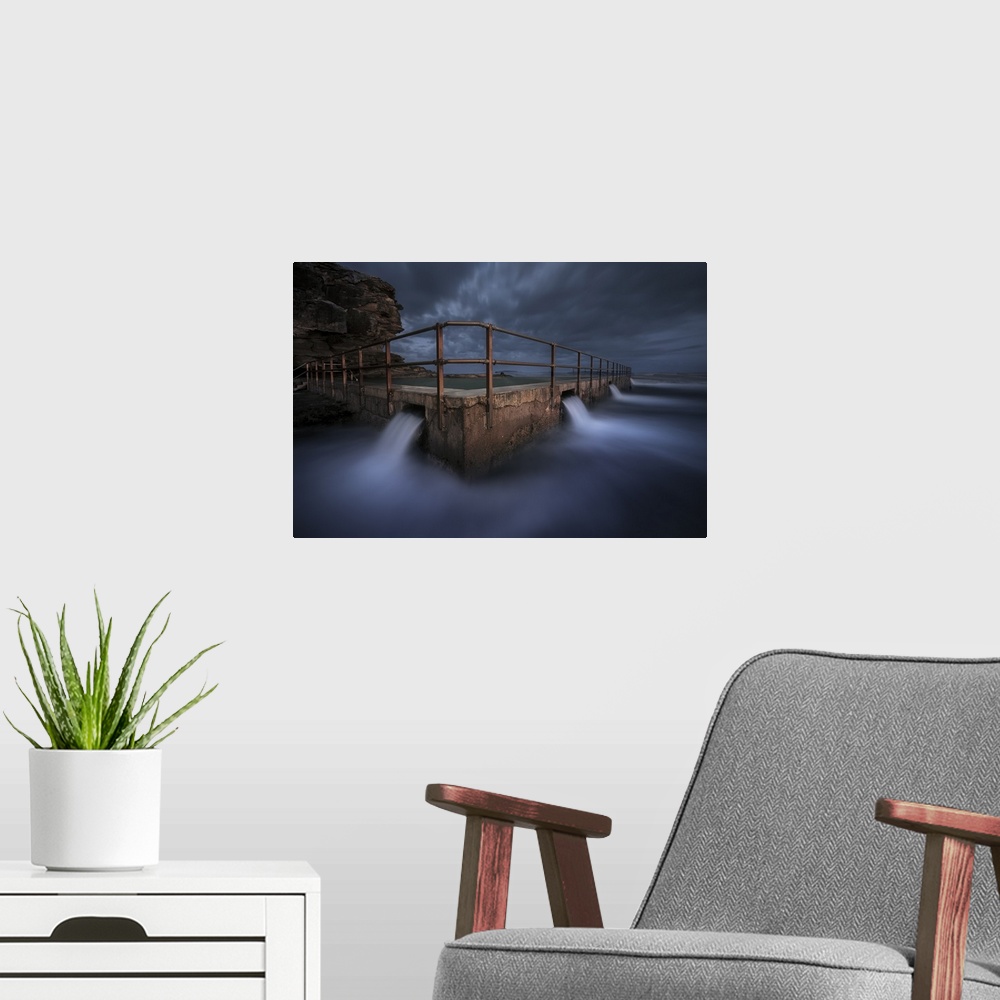 A modern room featuring Long exposure landscape photograph of the North Curl Rock Pool at night, Australia.