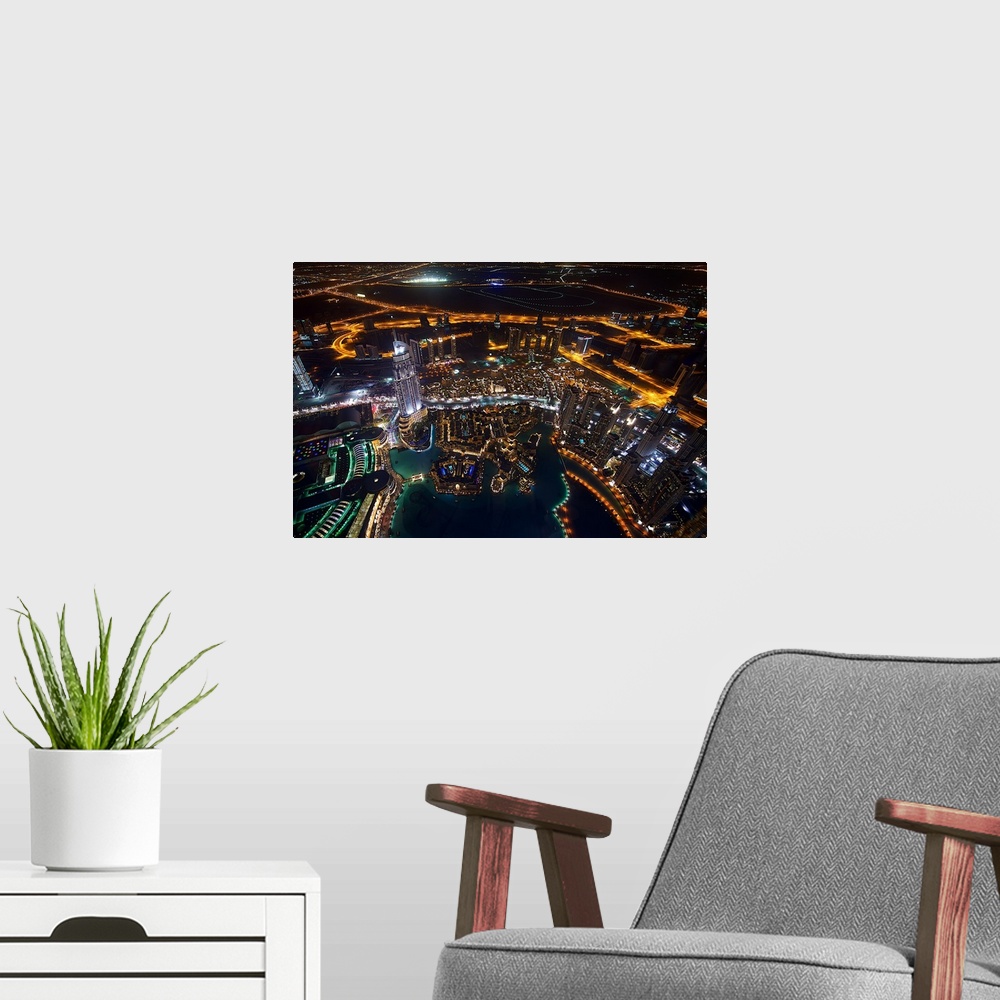 A modern room featuring Glowing cityscape view of Dubai at night.