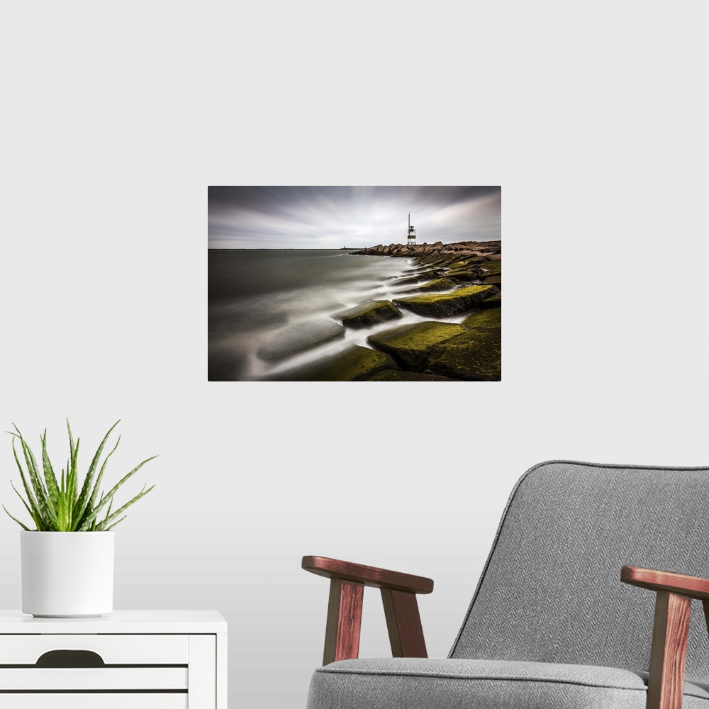 A modern room featuring Lighthouse on the rocky moss covered shoreline of IJmuiden, Netherlands.
