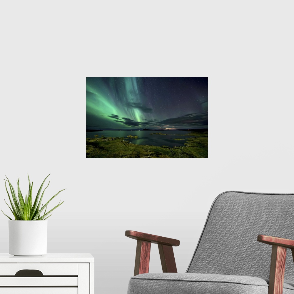 A modern room featuring The northern lights seen above Myvatn Lake in Iceland at night.